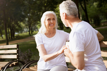 Obraz premium Mature couple on the bench in the park stock photo