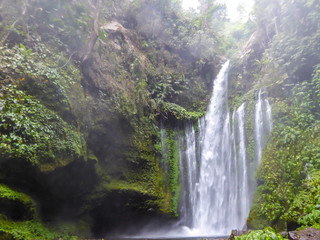 Sendang Gile waterfall captured just two days after the earthquake in August 2018, Lombok, Indonesia. The waterfall is surrounded by lush green plants from each side. Long and powerful waterfall.