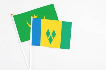 Saint Vincent And The Grenadines and Mauritania stick flags on white background. High quality...
