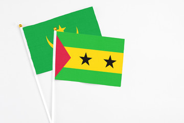 Sao Tome And Principe and Mauritania stick flags on white background. High quality fabric, miniature national flag. Peaceful global concept.White floor for copy space.