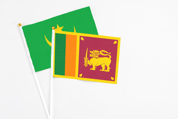 Sri Lanka and Mauritania stick flags on white background. High quality fabric, miniature national flag. Peaceful global concept.White floor for copy space.