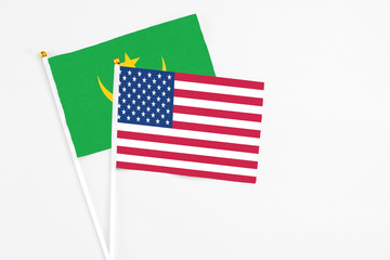 United States and Mauritania stick flags on white background. High quality fabric, miniature national flag. Peaceful global concept.White floor for copy space.