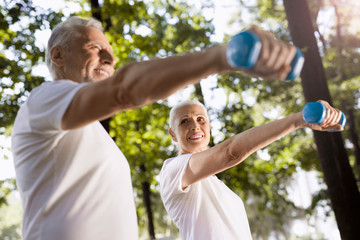 Cheerful woman holding hand weight stock photo