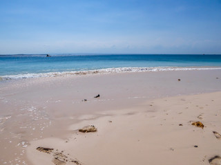 An idyllic Pink Beach on Lombok, Indonesia. Sea is calm, shining with many shades of blue. Beauty in the nature. Unspoiled, hidden gem. Perfect place for peaceful and relaxed holidays.