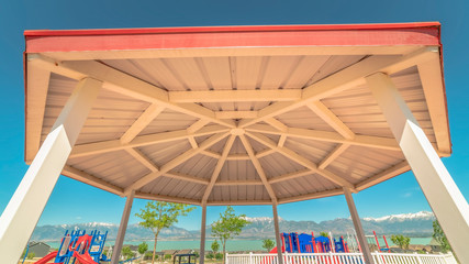 Panorama Octagon shape pavilion and playground with lake and Timpanogos mountains view