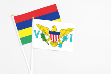 United States Virgin Islands and Mauritius stick flags on white background. High quality fabric, miniature national flag. Peaceful global concept.White floor for copy space.