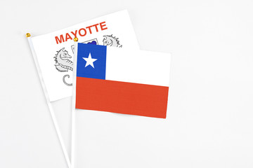 Chile and Mayotte stick flags on white background. High quality fabric, miniature national flag. Peaceful global concept.White floor for copy space.