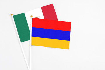 Armenia and Mexico stick flags on white background. High quality fabric, miniature national flag. Peaceful global concept.White floor for copy space.