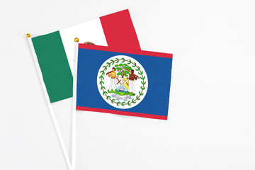 Belize and Mexico stick flags on white background. High quality fabric, miniature national flag. Peaceful global concept.White floor for copy space.