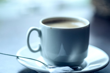 Cup of coffee in a cafe. Photographed close-up.