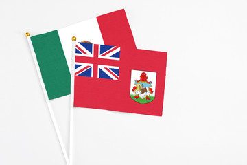 Bermuda and Mexico stick flags on white background. High quality fabric, miniature national flag. Peaceful global concept.White floor for copy space.