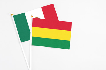 Bolivia and Mexico stick flags on white background. High quality fabric, miniature national flag. Peaceful global concept.White floor for copy space.