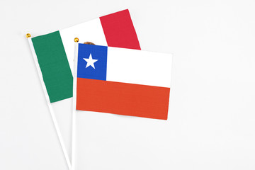 Chile and Mexico stick flags on white background. High quality fabric, miniature national flag. Peaceful global concept.White floor for copy space.