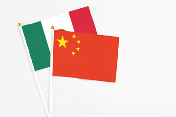 China and Mexico stick flags on white background. High quality fabric, miniature national flag. Peaceful global concept.White floor for copy space.
