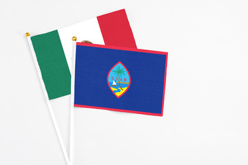 Guam and Mexico stick flags on white background. High quality fabric, miniature national flag. Peaceful global concept.White floor for copy space.