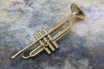 Fototapeta na wymiar miniature isolated metal trumpet closeup