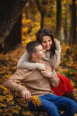Fototapeta premium Young couple having fun in the autumn park