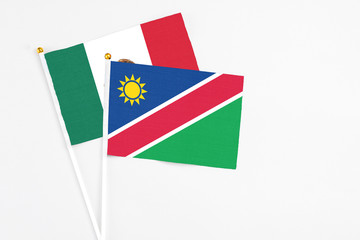 Namibia and Mexico stick flags on white background. High quality fabric, miniature national flag. Peaceful global concept.White floor for copy space.