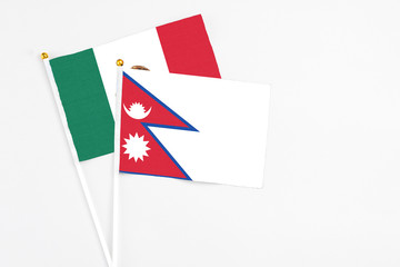 Nepal and Mexico stick flags on white background. High quality fabric, miniature national flag. Peaceful global concept.White floor for copy space.