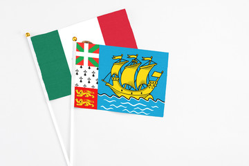 Saint Pierre And Miquelon and Mexico stick flags on white background. High quality fabric, miniature national flag. Peaceful global concept.White floor for copy space.