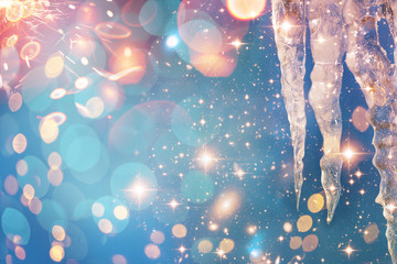 Christmas and New Year holidays background with icicle. Glitter lights backdrop. Winter season. Text space. Closeup of icicle. Elements of this Image Furnished by NASA.
