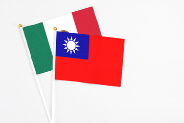 Taiwan and Mexico stick flags on white background. High quality fabric, miniature national flag. Peaceful global concept.White floor for copy space.