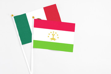 Tajikistan and Mexico stick flags on white background. High quality fabric, miniature national flag. Peaceful global concept.White floor for copy space.