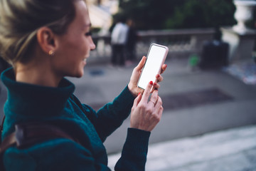 Happy hipster girl watching funny video on smartphone with copy space area for website for...