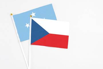 Czech Republic and Micronesia stick flags on white background. High quality fabric, miniature national flag. Peaceful global concept.White floor for copy space.