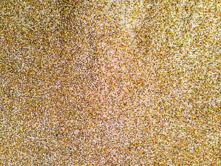 Close up of gold sparkle glitter fabric texture background
