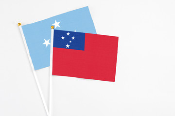 Samoa and Micronesia stick flags on white background. High quality fabric, miniature national flag. Peaceful global concept.White floor for copy space.