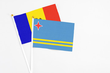 Aruba and Moldova stick flags on white background. High quality fabric, miniature national flag. Peaceful global concept.White floor for copy space.