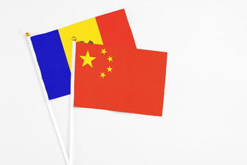 China and Moldova stick flags on white background. High quality fabric, miniature national flag. Peaceful global concept.White floor for copy space.