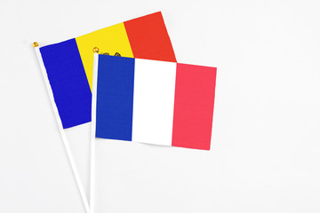 France and Moldova stick flags on white background. High quality fabric, miniature national flag. Peaceful global concept.White floor for copy space.