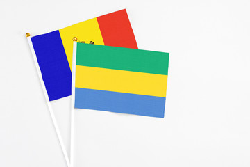 Gabon and Moldova stick flags on white background. High quality fabric, miniature national flag....