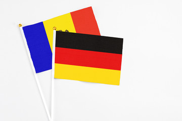 Germany and Moldova stick flags on white background. High quality fabric, miniature national flag. Peaceful global concept.White floor for copy space.