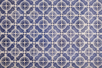 Wall with traditional Portuguese decor tiles azulezhu in blue tones.