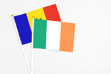 Ireland and Moldova stick flags on white background. High quality fabric, miniature national flag. Peaceful global concept.White floor for copy space.