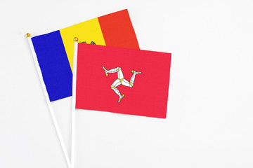 Isle Of Man and Moldova stick flags on white background. High quality fabric, miniature national flag. Peaceful global concept.White floor for copy space.