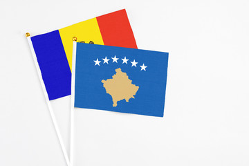 Kosovo and Moldova stick flags on white background. High quality fabric, miniature national flag. Peaceful global concept.White floor for copy space.