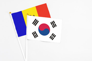 South Korea and Moldova stick flags on white background. High quality fabric, miniature national flag. Peaceful global concept.White floor for copy space.