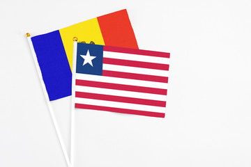 Liberia and Moldova stick flags on white background. High quality fabric, miniature national flag. Peaceful global concept.White floor for copy space.