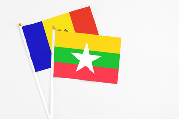 Myanmar and Moldova stick flags on white background. High quality fabric, miniature national flag. Peaceful global concept.White floor for copy space.