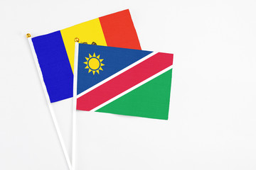 Namibia and Moldova stick flags on white background. High quality fabric, miniature national flag. Peaceful global concept.White floor for copy space.