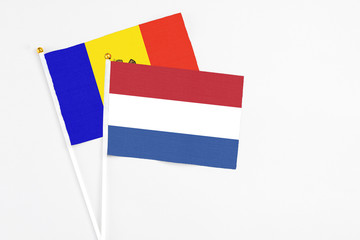 Netherlands and Moldova stick flags on white background. High quality fabric, miniature national flag. Peaceful global concept.White floor for copy space.