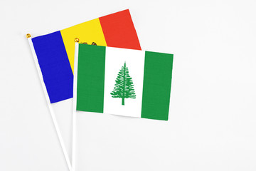 Norfolk Island and Moldova stick flags on white background. High quality fabric, miniature national flag. Peaceful global concept.White floor for copy space.