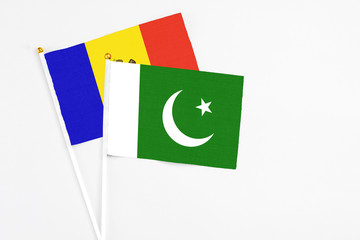 Pakistan and Moldova stick flags on white background. High quality fabric, miniature national flag. Peaceful global concept.White floor for copy space.