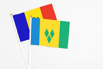 Saint Vincent And The Grenadines and Moldova stick flags on white background. High quality fabric, miniature national flag. Peaceful global concept.White floor for copy space.