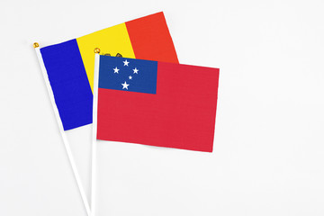 Samoa and Moldova stick flags on white background. High quality fabric, miniature national flag. Peaceful global concept.White floor for copy space.