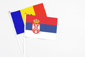 Serbia and Moldova stick flags on white background. High quality fabric, miniature national flag. Peaceful global concept.White floor for copy space.